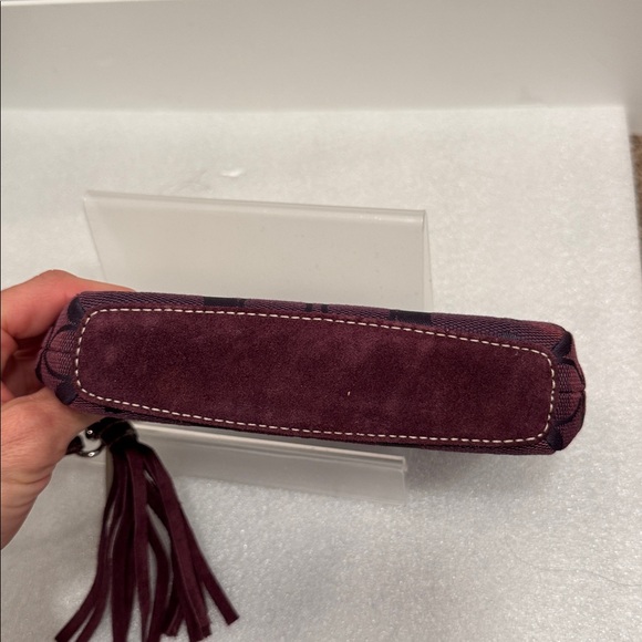 Coach Dark Purple Signature Wristlet wallet with medal hangtag